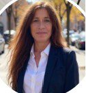 Professional woman with long hair wearing a blazer and white shirt.